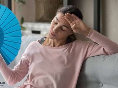 Image of a lady using a hand fan