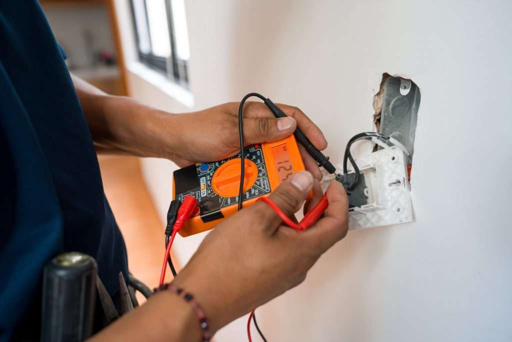 worker fixing wires with a machine