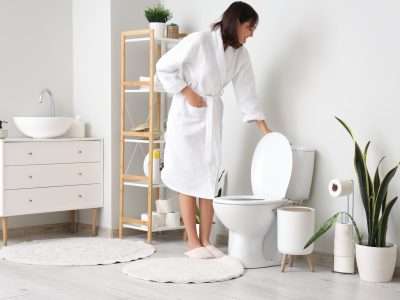 Person flushing toilet